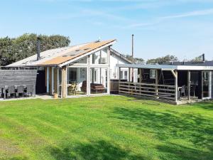 a house with a large lawn in front of it at 12 person holiday home in Vinderup-By Traum in Vinderup
