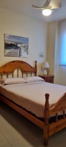 a bedroom with a wooden bed with a wooden frame at Las tres palmeras in Vinarós +32 photos