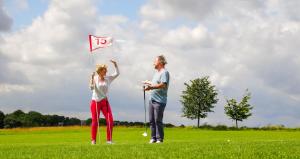 a man and a woman flying a red flag at Ferienwohnung life is life in Boltenhagen