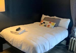 a white bed with a phone on top of it at The Madison House in Minneapolis