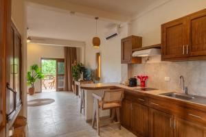 a kitchen with wooden cabinets and a counter top at Hotel Arena in Holbox Island