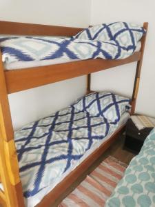 two bunk beds in a room with a bed at Apartmani Betina - Petra Preradovića 2K in Betina
