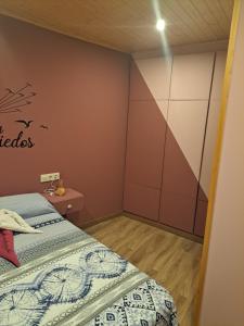 1 dormitorio con cama y pared en Casa Justa en Castrelo de Miño