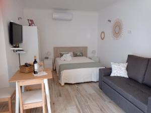a living room with a bed and a couch at Casinha2 in Amieira