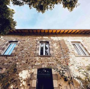 a brick building with a door and two windows at LesCinqSuites/ Le Marrakech - DABNB in Limoges