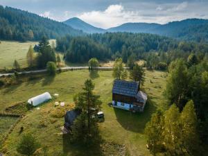 an aerial view of a barn and a truck in a field at Vukov Konak - Wolf's lodge in Žabljak