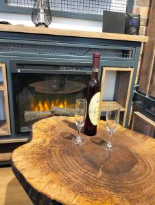 a wooden table with two wine glasses and a fireplace at Matrix in Jahorina