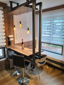 a dining room with a table with a bottle of wine at Matrix in Jahorina