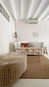 a living room with a couch and a table at Casa Petita, Villajoyosa in Villajoyosa