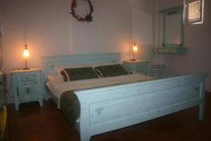 a bedroom with a bed with two nightstands and two lamps at Apartments Savina in Budva