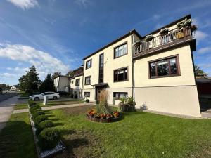 a large white house with a balcony on a yard at Magical two bedroom apartment in Viljandi in Viljandi