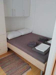 a bed sitting in a room with a table at Apartman Bruna in Zagreb
