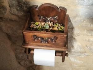 a wooden toilet paper holder with some animals on it at Casa Lidia - Antigua Posada Real in Valderrobres