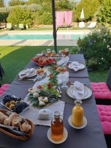 a long table with food and drinks on it at La Colombe in Tourrettes