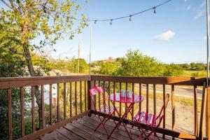 a table and chairs on a porch with a swing at Divine Cargo in San Antonio