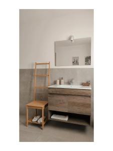 a bathroom with a sink and a ladder and a mirror at Affittacamere Al Vicolo in Ponte in Valtellina