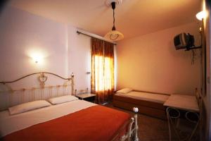 Postel nebo postele na pokoji v ubytování Hotel Rigakis
