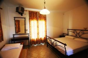 Postel nebo postele na pokoji v ubytování Hotel Rigakis