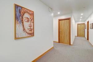 a painting of a woman on a wall in a hallway at Super OYO Townhouse 1232 White Sand in Dehradun