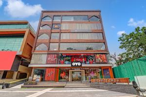 a tall building with a store in front of it at Super OYO Townhouse 1232 White Sand in Dehradun