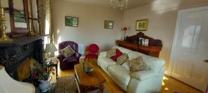 a living room with a white couch and a table at The Villa Farmhouse in Cushendun