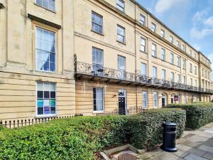 a large building with a balcony on the side of it at Margaret's Loft in Cheltenham