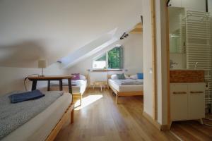 a bedroom with two beds and a table in a room at Ski House Szczyrk - Czyrna in Szczyrk