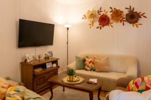 a living room with a couch and a flat screen tv at Apartman Rita in Bjelovar