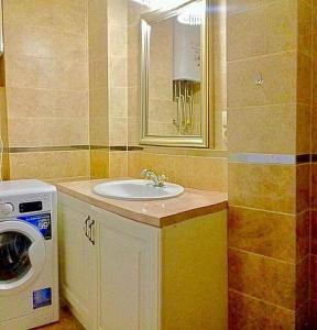 a bathroom with a sink and a washing machine at Fantasy in Karlovy Vary +28 photos