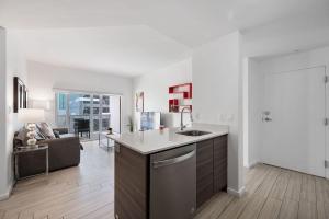 a kitchen with a sink and a living room at Subtle 2 Bed in Edgewater Downtown with Free Parking in Miami