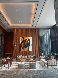 a lobby with couches and tables in a building at [300m to PRJ] Expo Friendly 2BR in Jakarta