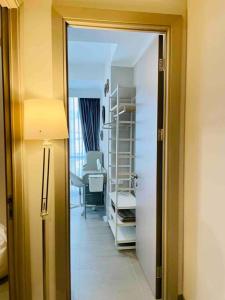 a hallway with a room with a bed and a desk at [300m to PRJ] Expo Friendly 2BR in Jakarta