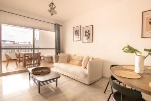 a living room with a couch and a table at Luxury apartment in Miraflores in La Cala de Mijas