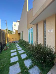 a walkway in front of a building with grass at POUSADA Dona Ziza in Maringá