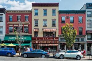 a city street with cars parked in front of buildings at Spacious Oasis - Hoboken California King Bed! in Hoboken