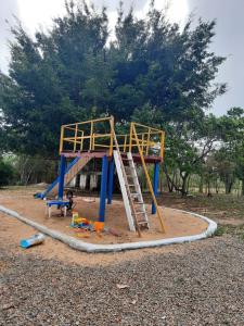 a playground with a ladder in a park at Valle dos ipês in Tianguá