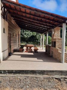 a patio with a picnic table and a brick building at Valle dos ipês in Tianguá