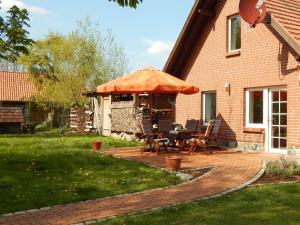 a patio with a table and an umbrella at Ferienhaus in Neu Poserin for 5 Personen in Neu Poserin