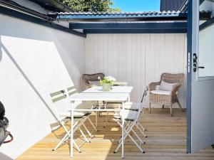 a white table and chairs on a patio at Holiday home Löderup V in Löderup