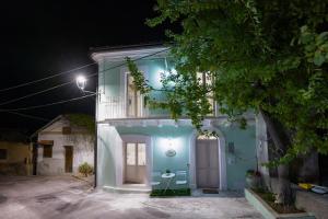 a blue house with a white door at night at Tullia -intera casa- in Giuliano Teatino