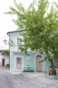 a blue and white house with a tree in front of it at Tullia -intera casa- in Giuliano Teatino
