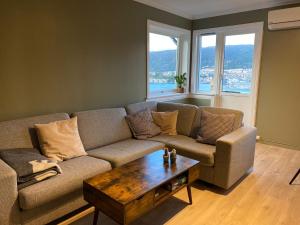 a living room with a couch and a coffee table at Beautiful apartment with amazing view in Bergen