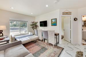 a living room with a couch and a table at Anaheim Hills Retreat with Private Backyard and Pool! in Anaheim