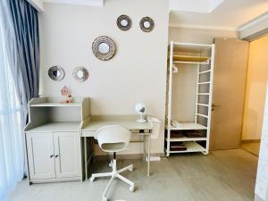 a desk and a chair in a room at [300m to PRJ] Expo Friendly 2BR in Jakarta