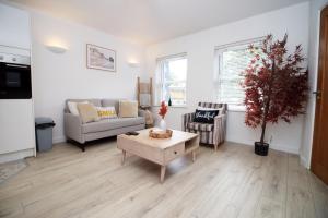 a living room with a couch and a table at Central Mumbles Apartment, Properties By O & G, Incredible Location, Sleeps 4! in The Mumbles