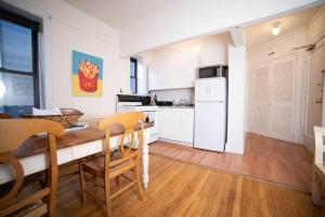 a kitchen with a table and chairs in a room at Cozy apartment in beautiful midtown Hoboken in Hoboken