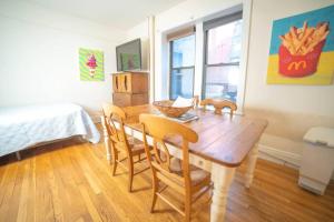 a dining room with a wooden table and chairs at Cozy apartment in beautiful midtown Hoboken in Hoboken