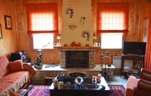 a living room with a couch and a fireplace at WOODEN IN WOODS 