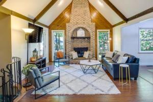 a living room with a couch and a fireplace at Overland Park Home with Fenced-In Yard and Gas Grill! in Overland Park