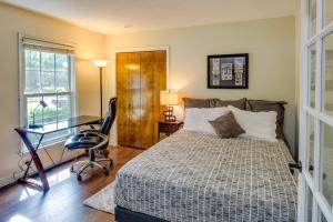 a bedroom with a bed and a desk and a chair at Overland Park Home with Fenced-In Yard and Gas Grill! in Overland Park